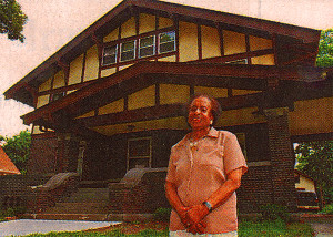 Miss Lucy Bevins in front of the WICS Home on the day they paid the rest of its mortgage in 2002.